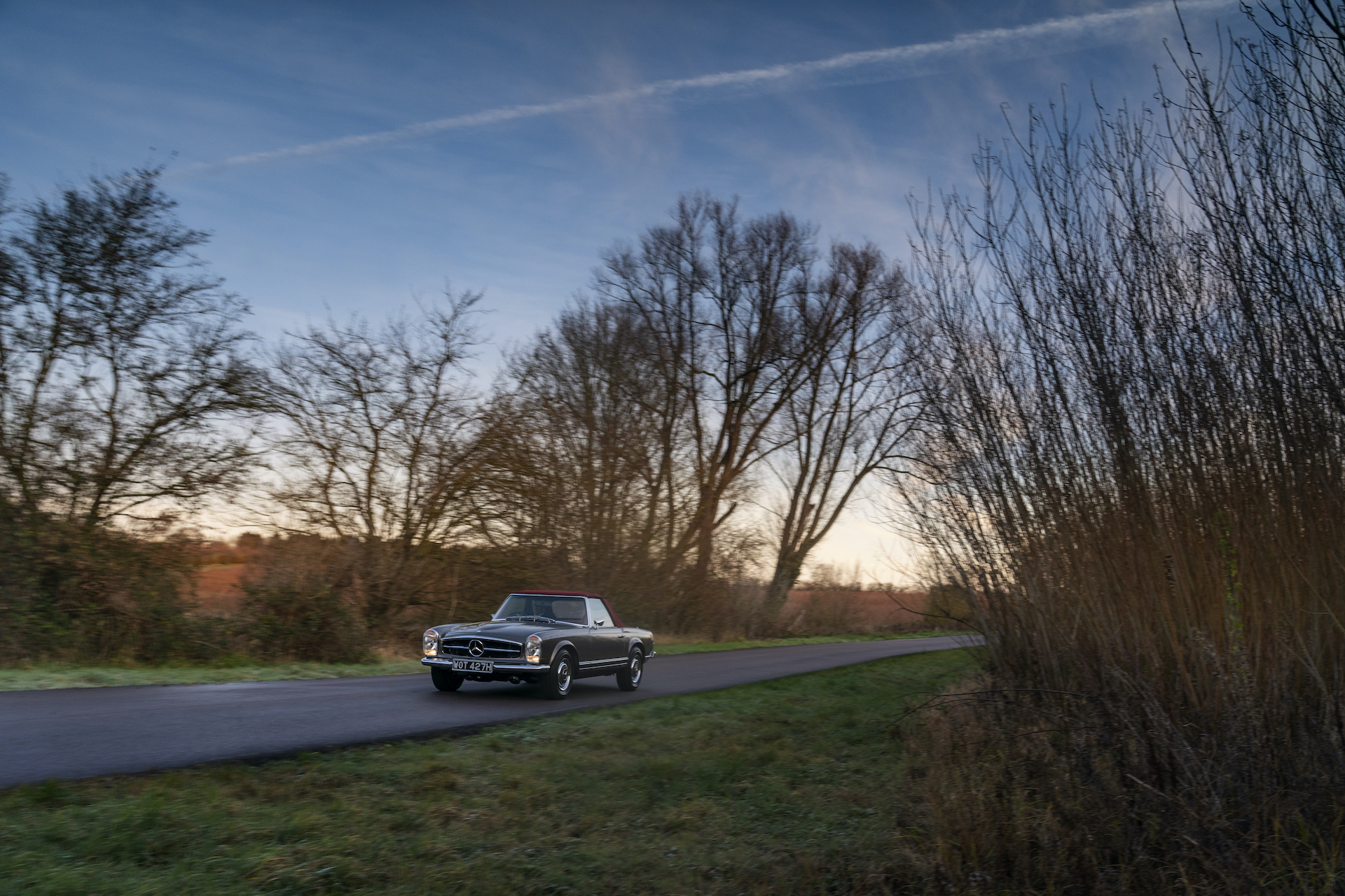 Fully restored Mercedes Pagoda driving down SLSHOP private road.