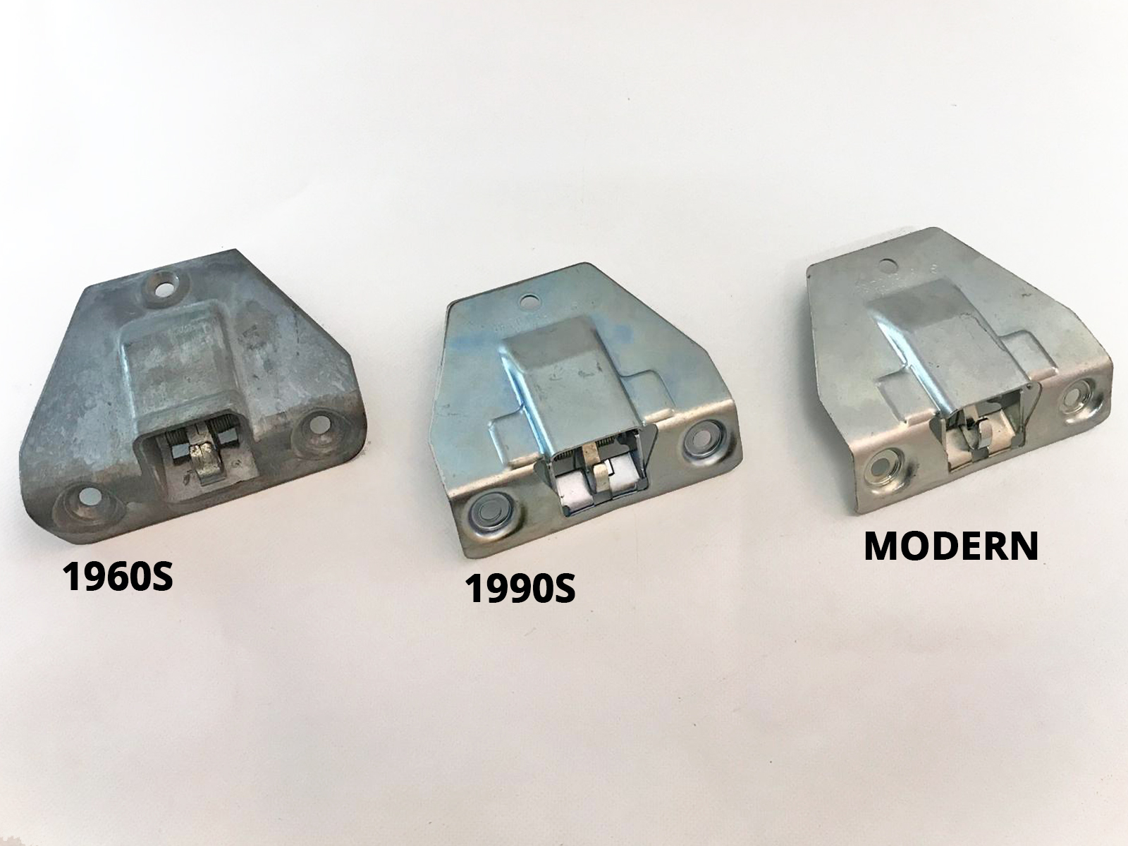 Three different generations of Mercedes parts - boot locks from the 60s, 90s and Millennium.