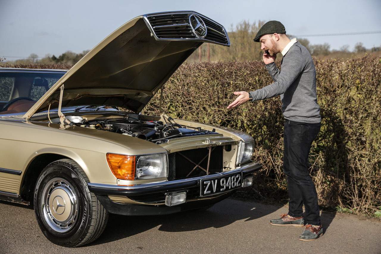 An SL owner stopped at the roadside inspecting the engine for problems following use of E10 Fuel.