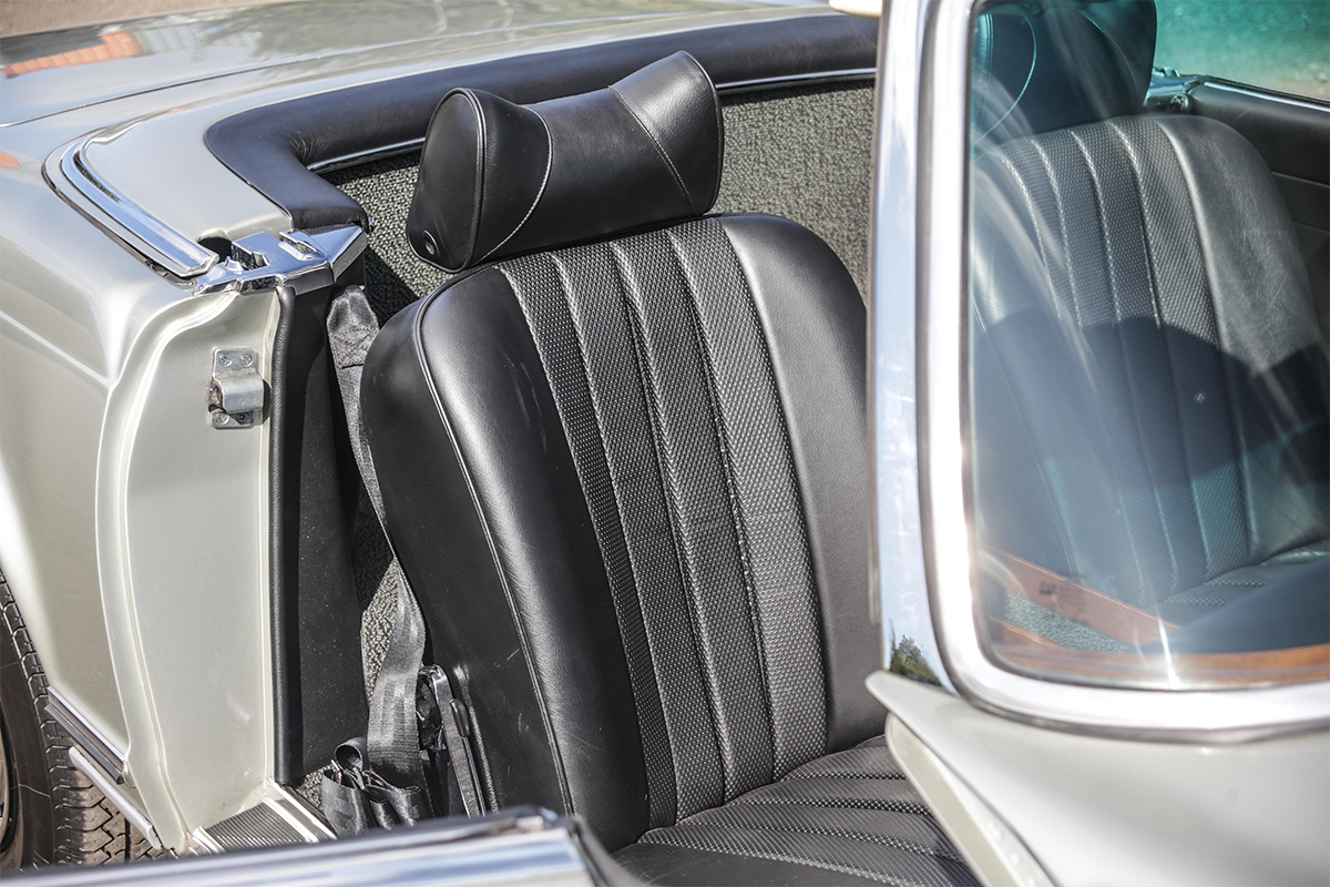 Black leather passenger seat of a 1970s Mercedes 280 SL